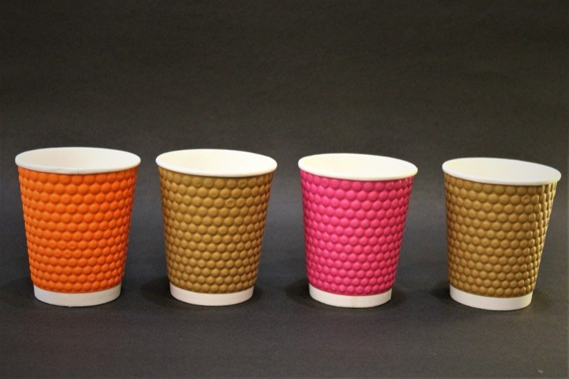 Four embossed double-wall cups in orange, kraft, pink and gold.